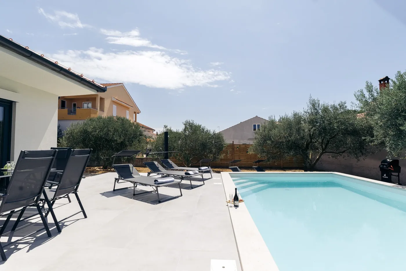 Pool with loungers and olive trees